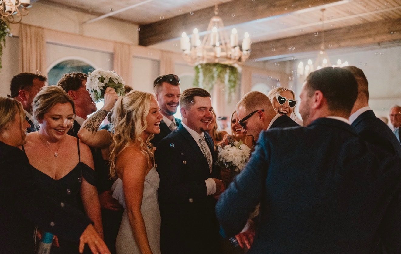 Wedding party celebrating with bouquet and bubbles