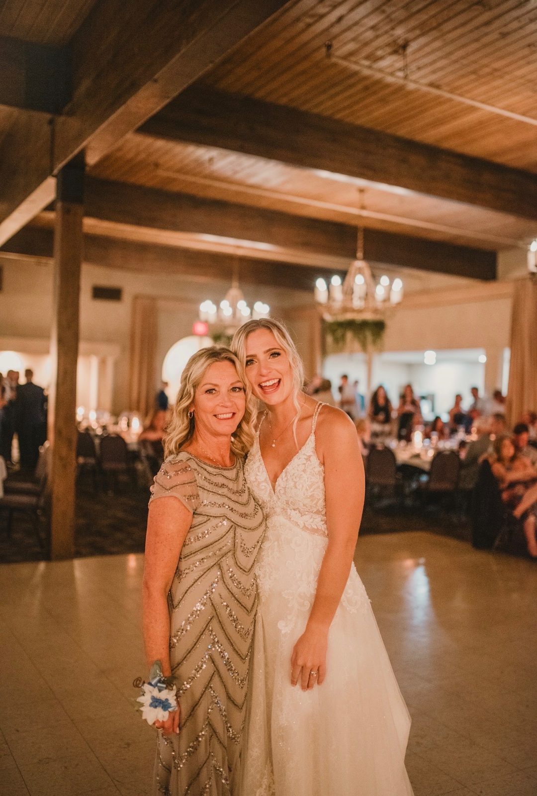 Bride posing with her mother on the dance floor