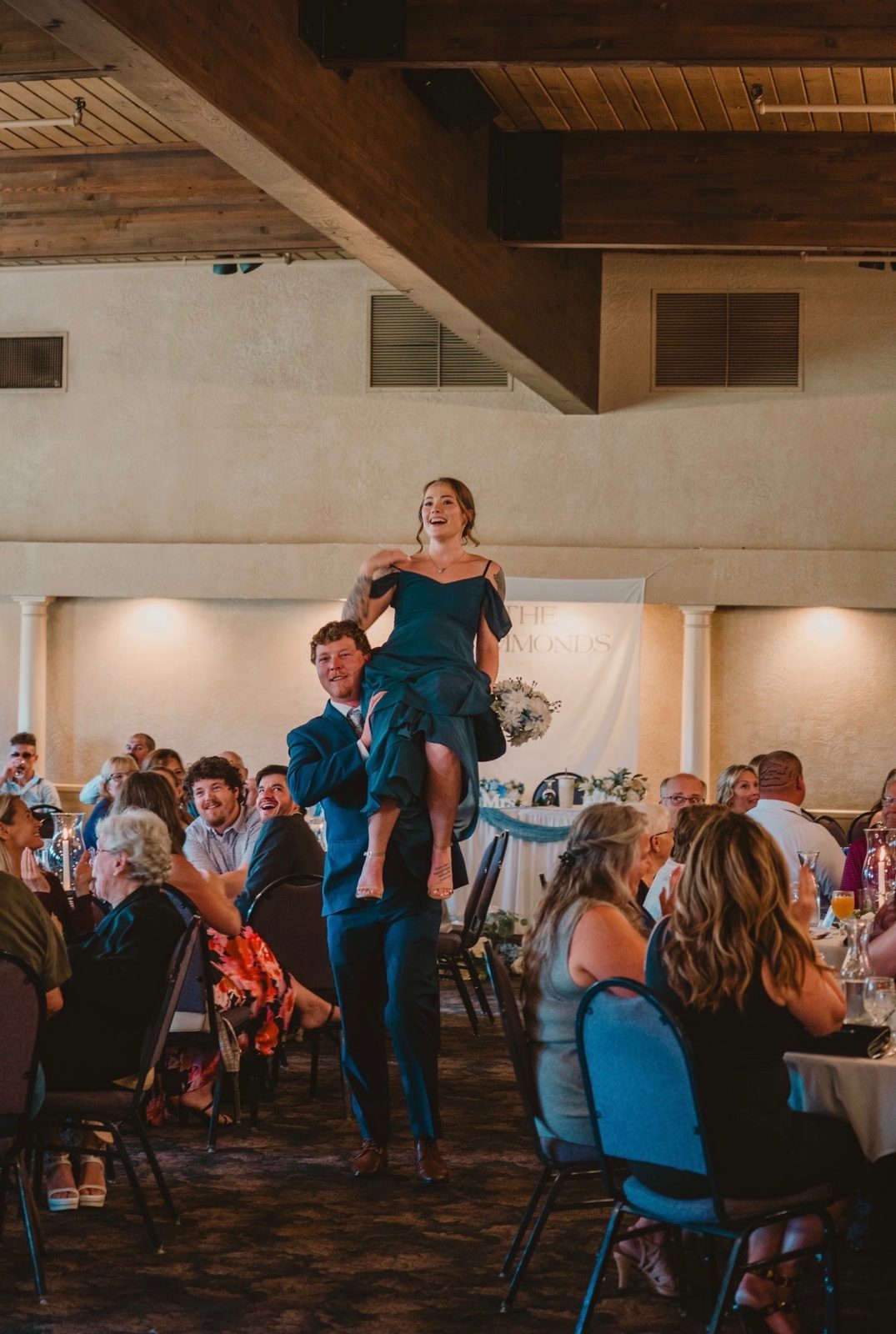 Groomsman lifting a bridesmaid on the dance floor