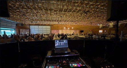 Full ballroom reception setup with string lighting